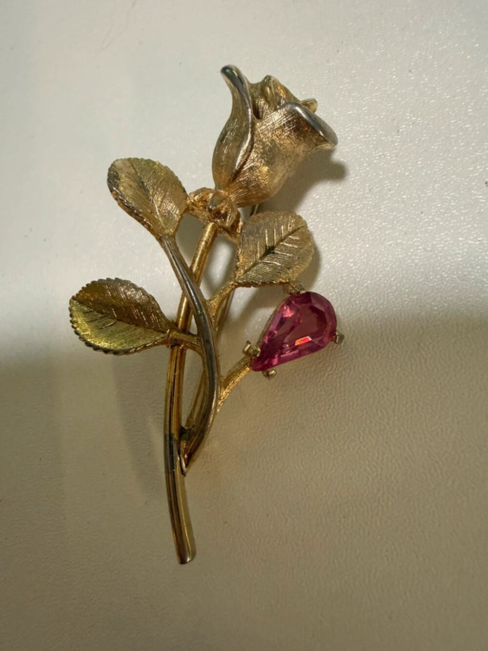 Vintage gold tone Avon rose brooch with faux pink sapphire accent